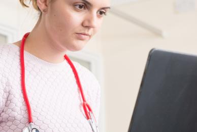 Doctor looking at laptop